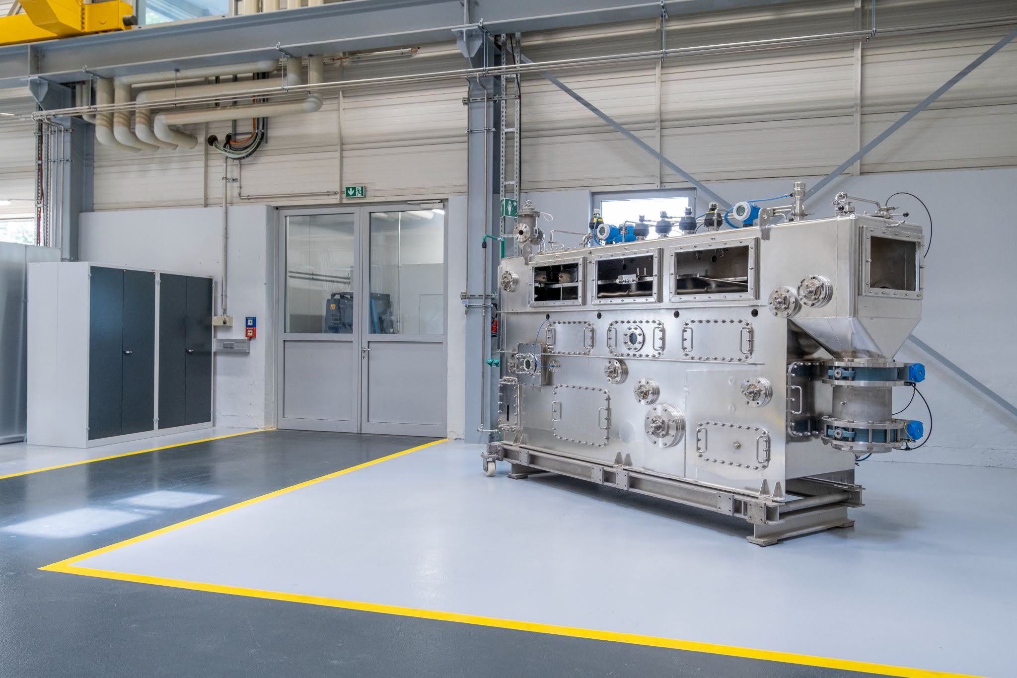 Large stainless steel BHS continuous filter installed on a clean production plant floor